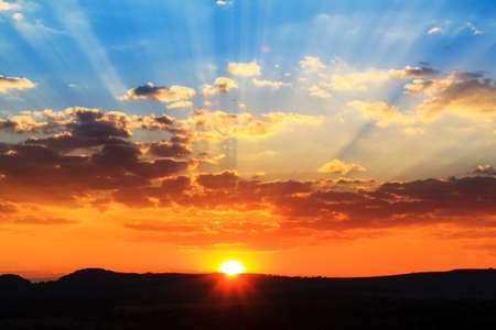 Beautiful powerful and vibrant sunset with sunbeamsの写真素材