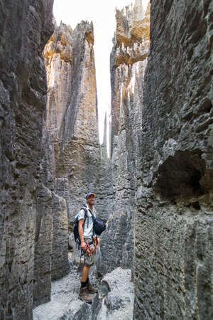 Adventurous tourist on an excursion in the unique limestone landscape at the Tsingy de Bemaraha Strict Nature Reserve in Madagascarの写真素材