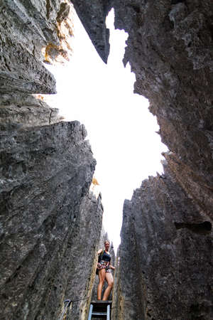 Beautiful tourist on an excursion in the unique limestone landscape at the Tsingy de Bemaraha Strict Nature Reserve in Madagascarの写真素材