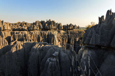 Beautiful tourist on an excursion in the unique limestone landscape at the Tsingy de Bemaraha Strict Nature Reserve in Madagascarの写真素材