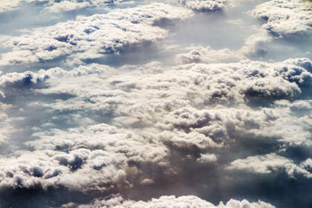 Aerial view on thick clouds in the sky seen from aboveの写真素材