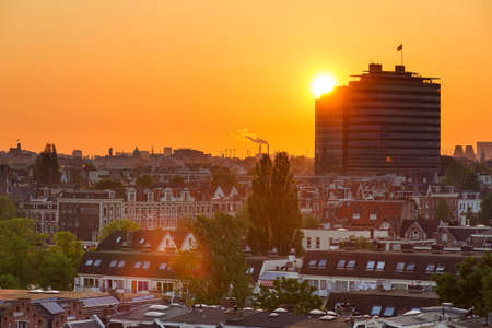 Beautiful cityscape looking over the city of Amsterdam in the Netherlands at sunsetの写真素材