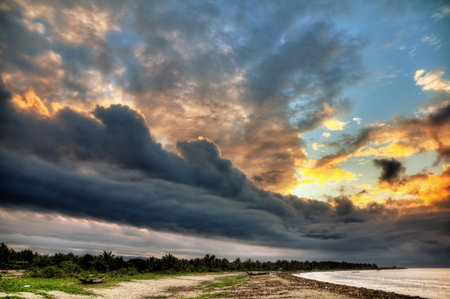 The coastline of Maroantsetra in Madagascar at sunrise with a dramatic sky in HDR