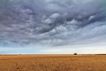 Beautiful minimalistic landscape in Iceland with a small shed in a wide landscape with an ominous cloudscapeの写真素材