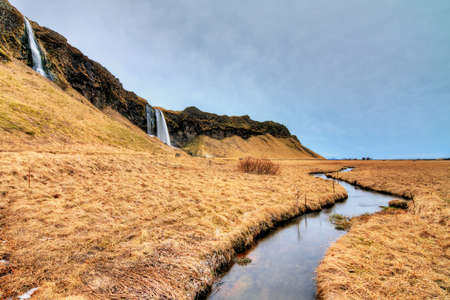 Beautiful view on a cascades and a stream near the Seljalandsfoss waterfall in Icelandの写真素材