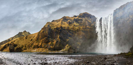 Beautiful 180 degree panorama of the magnificent Skogafoss waterfall in Icelandの写真素材