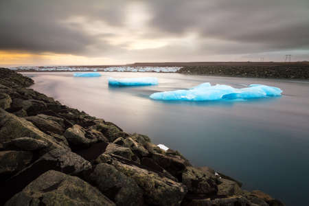 Beautiful view of the flowing water in the river leading to the sea from the Jokulsarlon lake with icebergs in winterの写真素材