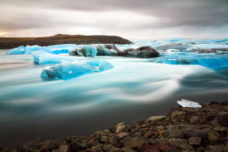 Beautiful view of the flowing water in the river leading to the sea from the Jokulsarlon lake with icebergs in winterの写真素材