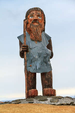 Random wooden statue of an Icelandic man in the landscape of Icelandの写真素材