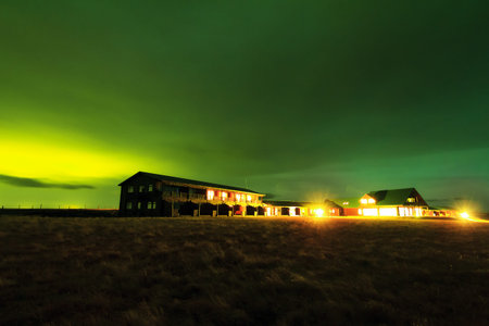 Beautiful nightscape landscape with green aurora borealis northern lights on a ranch in Iceland at...