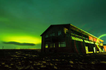 Beautiful nightscape landscape with green aurora borealis northern lights on a ranch in Iceland at night in winterの写真素材