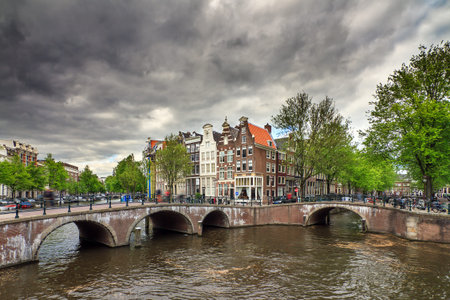 Beautiful clouds at the Emperors canal Keizersgracht canal in Amsterdam and Leiden in springの写真素材