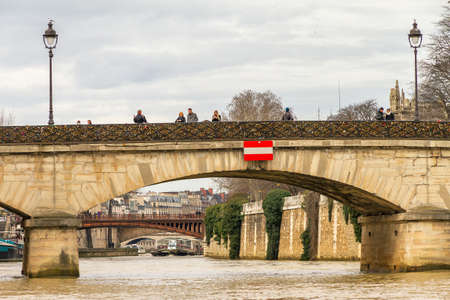 Tourists place padlocks on the Pont de l'Archeveche Archbishop's Bridge at the Notre-Dame cathedral in Paris on February 18, 2014のeditorial素材