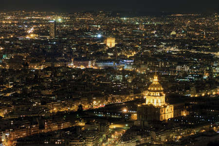 Beautiful aerial cityscape of Paris, France, at night with the Dome des Invalides and the Arc de Triompheの写真素材