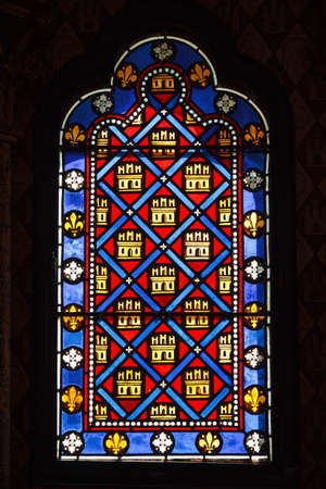 Beautiful colored ancient stained glass with a pattern of diamonds and castlesのeditorial素材