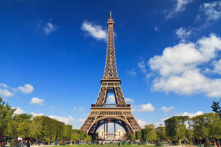 Beautiful vibrant spring view of the Eiffel tower in Paris, France, with a blue sky and some cloudsの写真素材