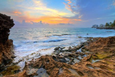 Beautiful sunrise at the rocky coast of San Juan, Puerto Rico, in summerの写真素材