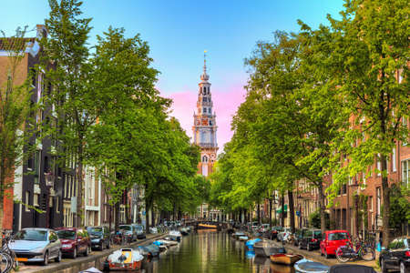 Beautiful Groenburgwal canal in Amsterdam with the Soutern church (Zuiderkerk) at sunset in summerの写真素材