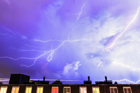 Thunder flashes in the sky over Amsterdam during a heavy thunderstorm in summer