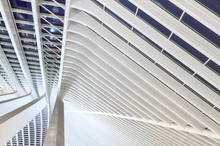 Beautiful abstract view of the interior of the modern architecture railway station Liege-Guillemins with steel shapes and lines in Belgiumの写真素材