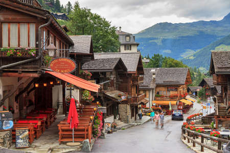 Tourists in the streets of the beautiful alpine village Grimentz, Switzerland, canton Valais, municipality Anniviers, on July 26, 2014のeditorial素材