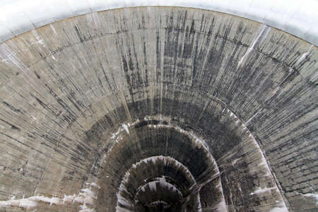 Beautiful view down the hole of the concrete water intake tower at the Moiry dam near Grimentz, Switzerlandの写真素材