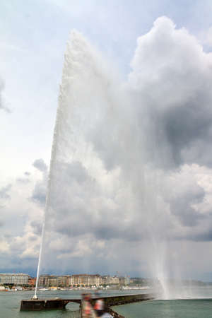 The Jet d'Eau fountain (water-jet fountain) in lake Geneva in Switzerland, one of the most famous landmarks of the cityの写真素材