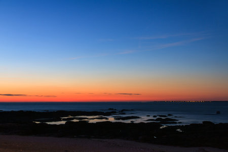 Beautiful landscape view of the vibrant sunset sky at the beach of the Loire-Atlantique in France on a sunny summer day in Julyの写真素材