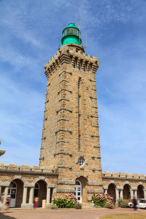 Beautiful wide view of the entrance of the new lighthouse at Cap FrÃ©hel in Brittany, France, with a blue sky in summerの写真素材