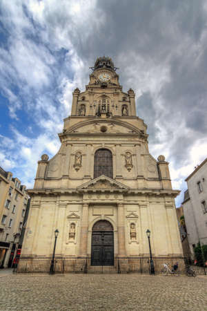 Beautiful wide angle view of the Église Sainte-Croix de Nantes in the city of Nantes, France, on a summer day with cloudsのeditorial素材