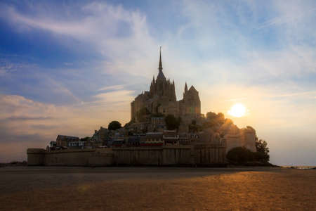 Beautiful view of historic landmark Le Mont Saint-Michel in Normandy, France, a famous UNESCO world heritage site and tourist attraction, silhouette at sunsetのeditorial素材