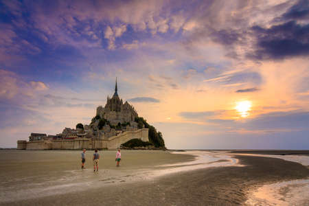 Tourist walk around historic landmark Le Mont Saint-Michel in Normandy, France,の写真素材