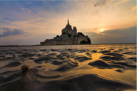 Beautiful view of historic landmark Le Mont Saint-Michel in Normandy, France, a famous UNESCO world heritage site and tourist attraction, at sunsetのeditorial素材