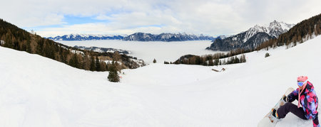 Beautiful panorama landscape of the slopes in winter with snowboarder in the Brandnertal in the...