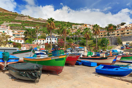 Beautiful view of the colored fisher boats in the Harbor of Camara de Lobos on the island of Madeira in summerの写真素材