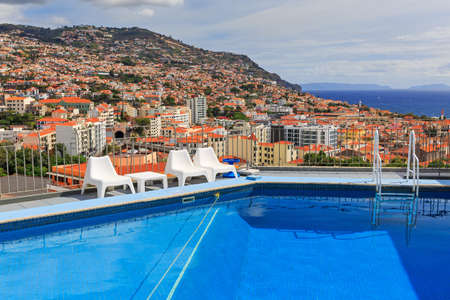 Beautiful cityscape view with blue swimming pool of Funchal on the island Madeira in summerの写真素材