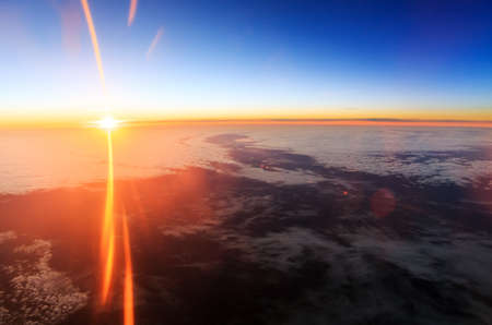Beautiful aerial sunrise cloudscape with a blue morning sky and bright summer sun in the Netherlandsの写真素材
