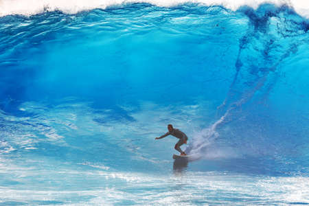 Surfer riding the big blue surf waves on the island Madeira, Portugal, a popular surfing tourist destination on October 8, 2015のeditorial素材