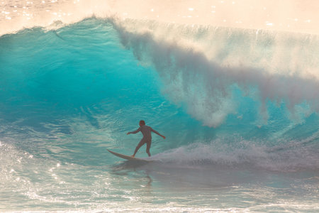 Surfer riding the big blue surf waves on the island Madeira, Portugal, a popular surfing tourist destination on October 8, 2015のeditorial素材