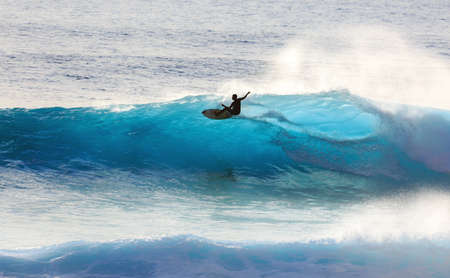 Surfer riding the big blue surf waves on the island Madeira, Portugal, a popular surfing tourist destination on October 8, 2015のeditorial素材