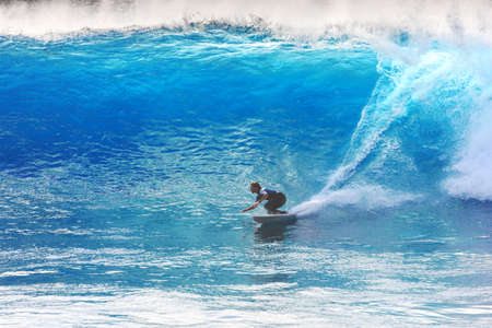 Surfer riding the big blue surf waves on the island Madeira, Portugal, a popular surfing tourist destination on October 8, 2015のeditorial素材