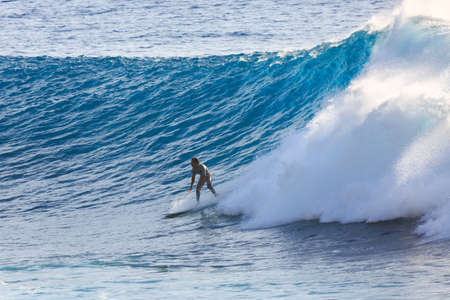 Surfer riding the big blue surf waves on the island Madeira, Portugal, a popular surfing tourist destination on October 8, 2015のeditorial素材
