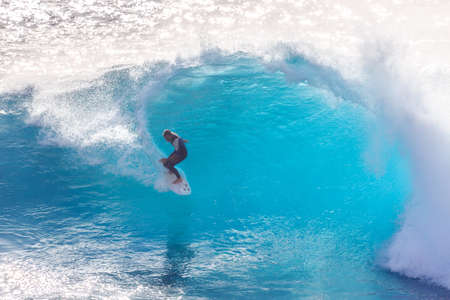 Surfer riding the big blue surf waves on the island Madeira, Portugal, a popular surfing tourist destination on October 8, 2015のeditorial素材