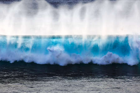 Beautiful seascape view of the big blue surf waves of the Atlantic ocean on the island Madeira, a popular surfing tourist destinationの写真素材