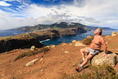 Tourist on the cliffs in the beautiful landscape of the east coast of Madeira at Ponta de Sao Lourenco nature reserveの写真素材