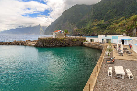 Beautiful landscape view of a natural swimming pool on the north coast of Madeira at Seixal, on a cloudy summer dayの写真素材