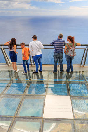 Tourists looking at the view at the Cabo Girao platform, a viewpoint on top of the big cliffs of the island Madeira, on October 11, 2015のeditorial素材