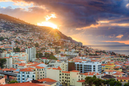 Beautiful skyline cityscape of the city Funchal on the island Madeira at sunrise in summerの写真素材