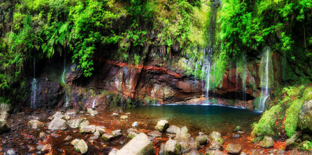 Beautiful panorama landscape of the 25 Fontes falls, a cascade waterfall at the end of a levada hike...