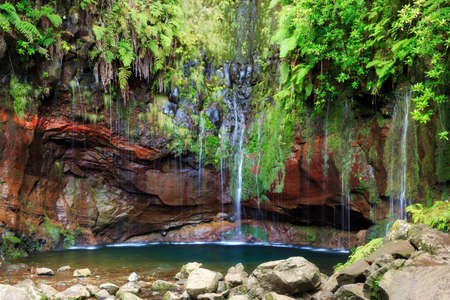 Beautiful landscape view of the 25 Fontes falls, a cascade waterfall at the end of a levada hike on the island of Madeiraの写真素材